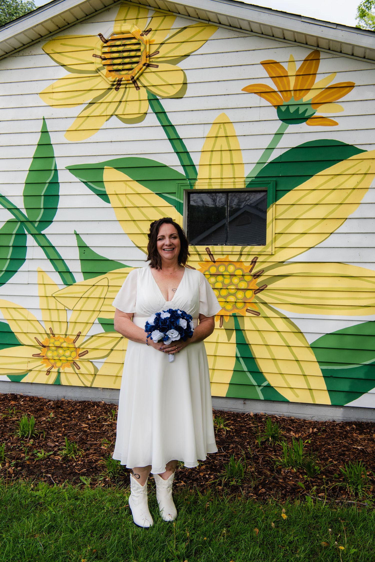 Wedding photos against a vibrant wall mural featuring large yellow flowers and green leaves.