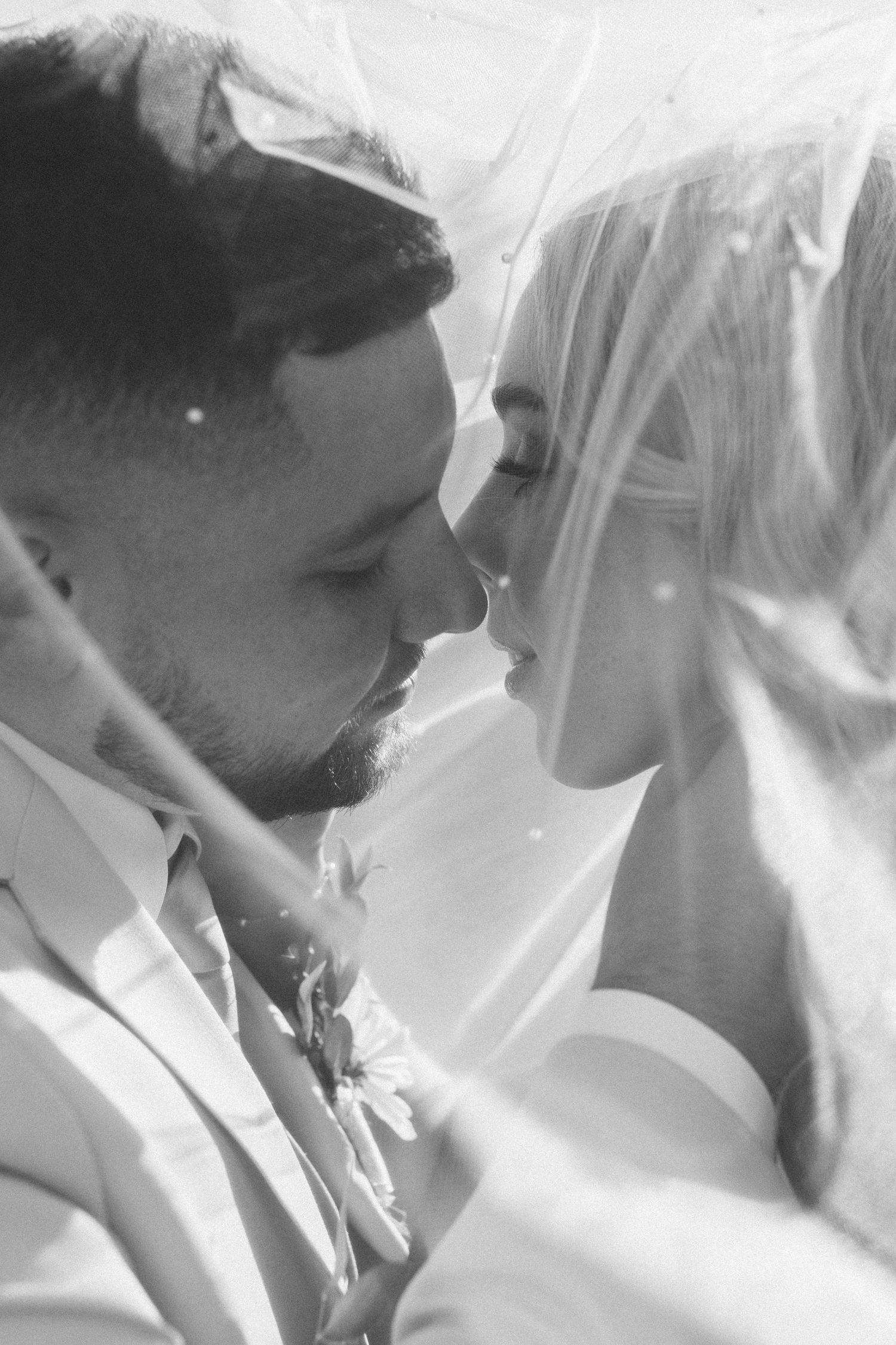 Ethereal black and white image of flowing bridal veil fabric in natural light.
