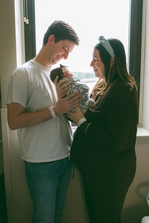 A series of three connected images showing a couple embracing near a window in casual attire.