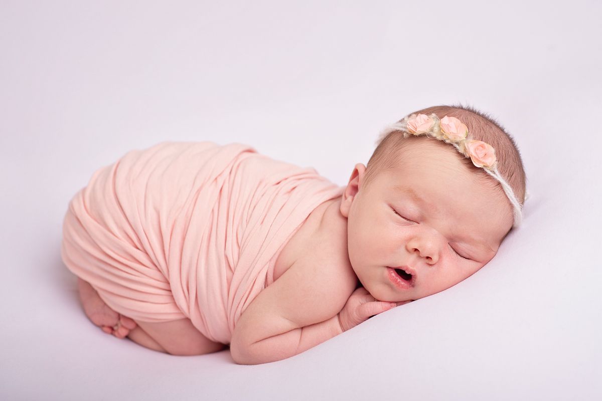 newborn baby girl, sleeping on tummy in pink blanket for her newborn baby photoshoot in Baltimore Ontario, 25 minutes from Newcastle*