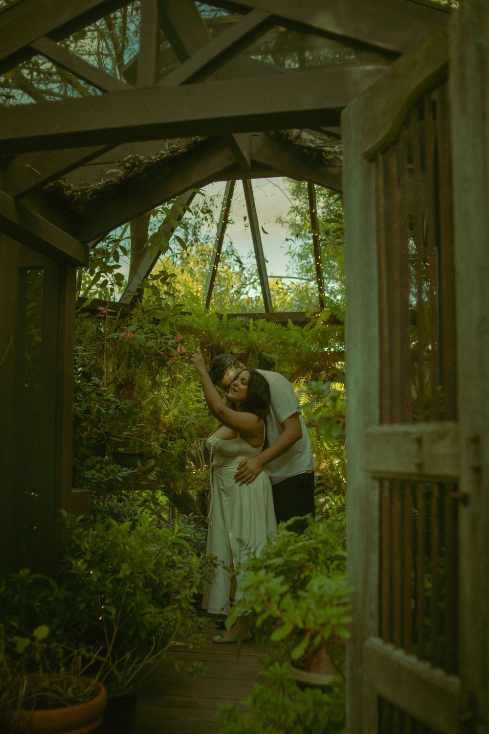 Dreamy cinematic engagement photography in a greenhouse in San Diego California