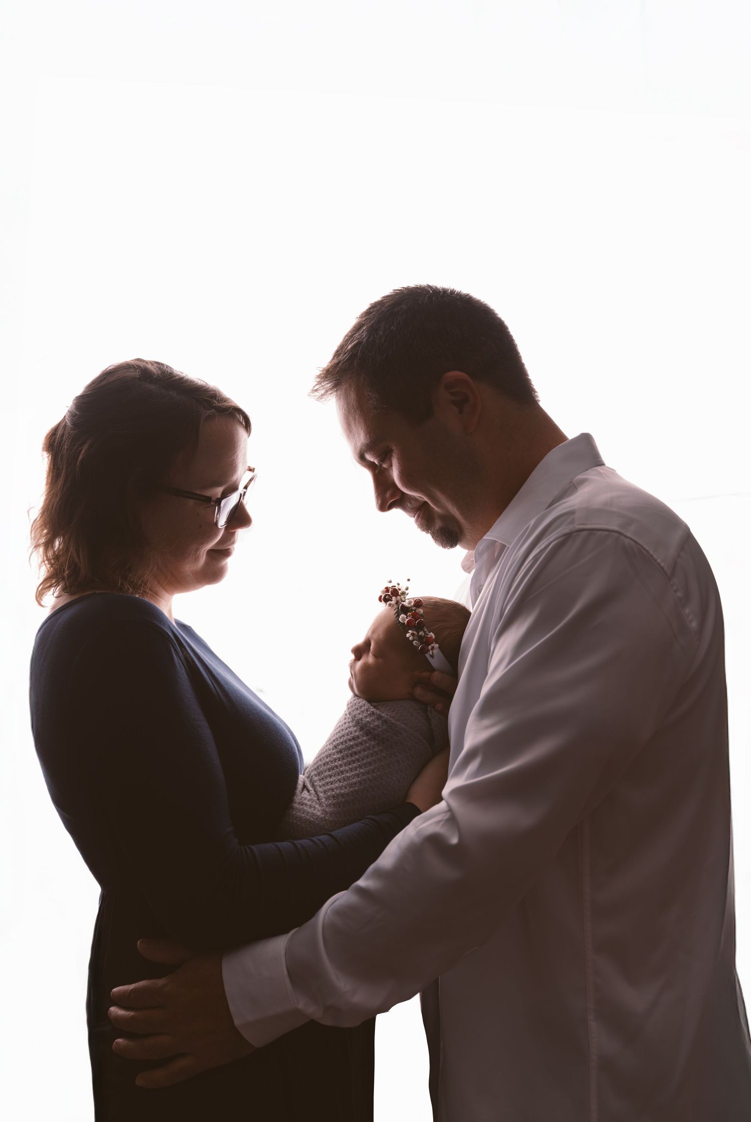 Silhouetted figures sharing intimate moments against white background.