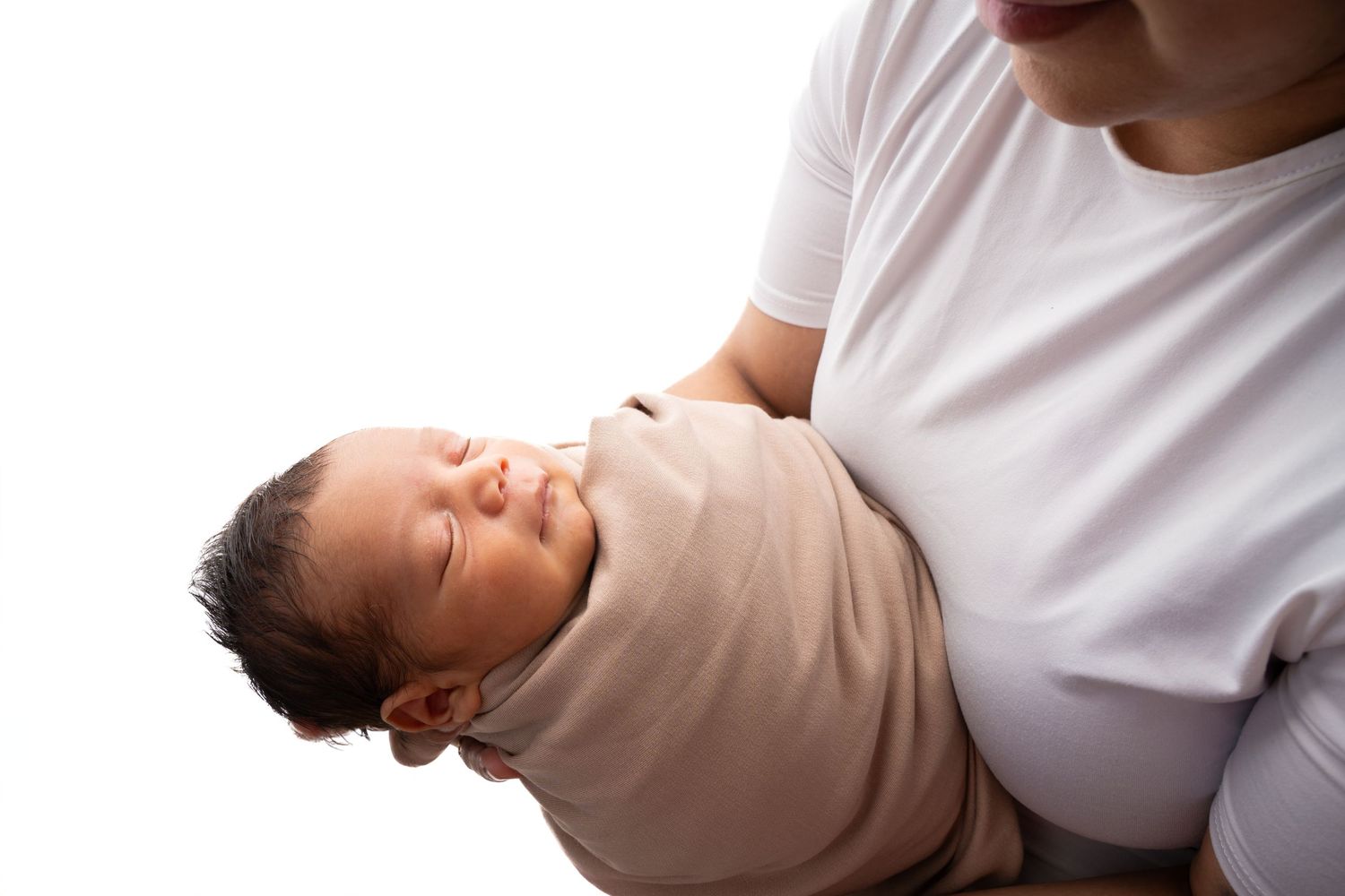 Tender moments between parent and newborn in white studio setting.