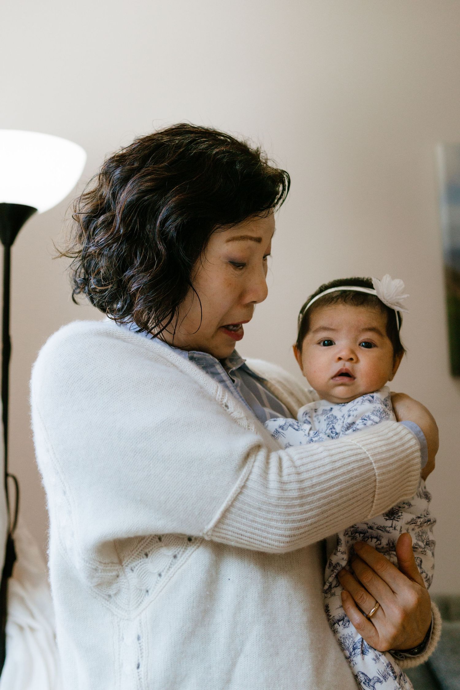 A funny moment captured between grandmother and newborn baby as they are photographed by Cherry Hill newborn photographer.