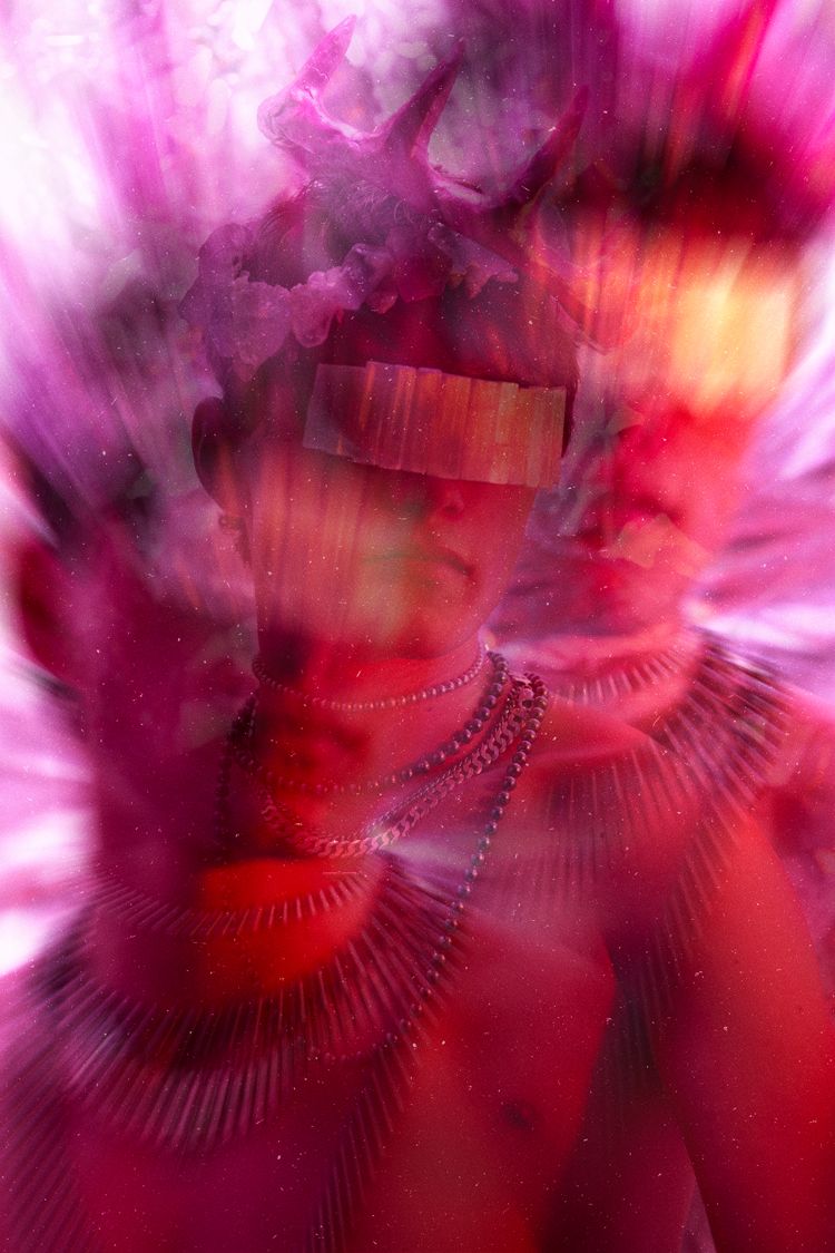 Abstract portrait in swirling pink and red tones with smoky effect.