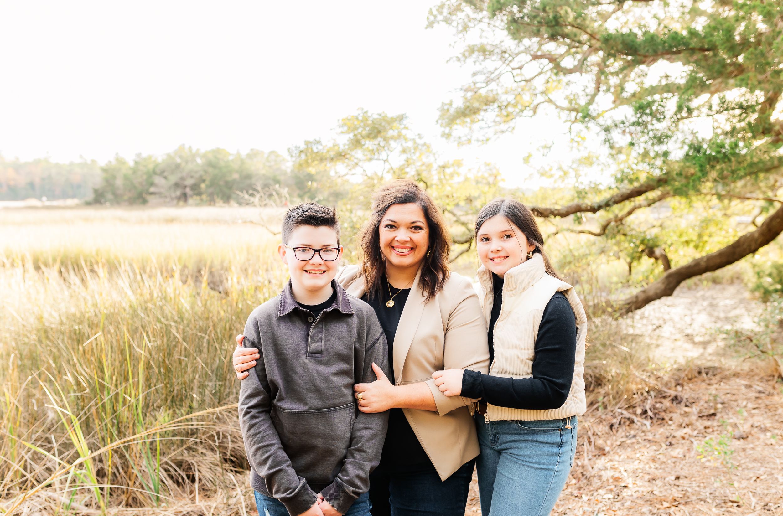 Family portrait session under moss-draped oak trees in autumn.PRESLEY ROSE PHOTOGRAPHY OCEAN ISLE BEACH SUNSET BEACH BRUNSWICK BEACH NMB