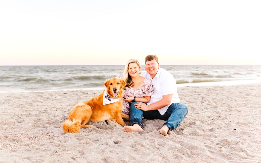 Beach family photos with a golden retriever dog on sandy shore.PRESLEY ROSE PHOTOGRAPHY OCEAN ISLE BEACH SUNSET BEACH BRUNSWICK BEACHES