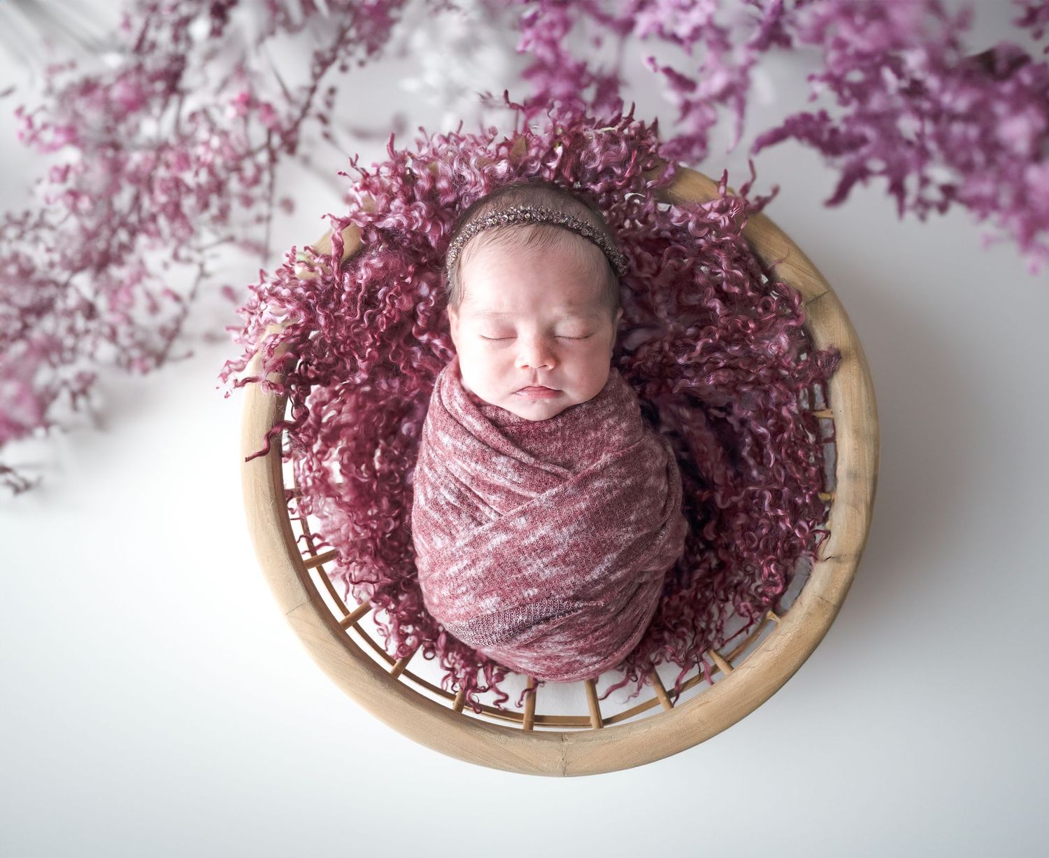 Baby girl in a basket floral pink