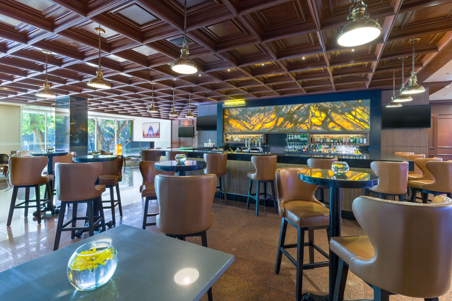 Loby bar at Barcelo Mexico Reforma with high-top seating and decorative wood-paneled ceiling. HDR finished Image.