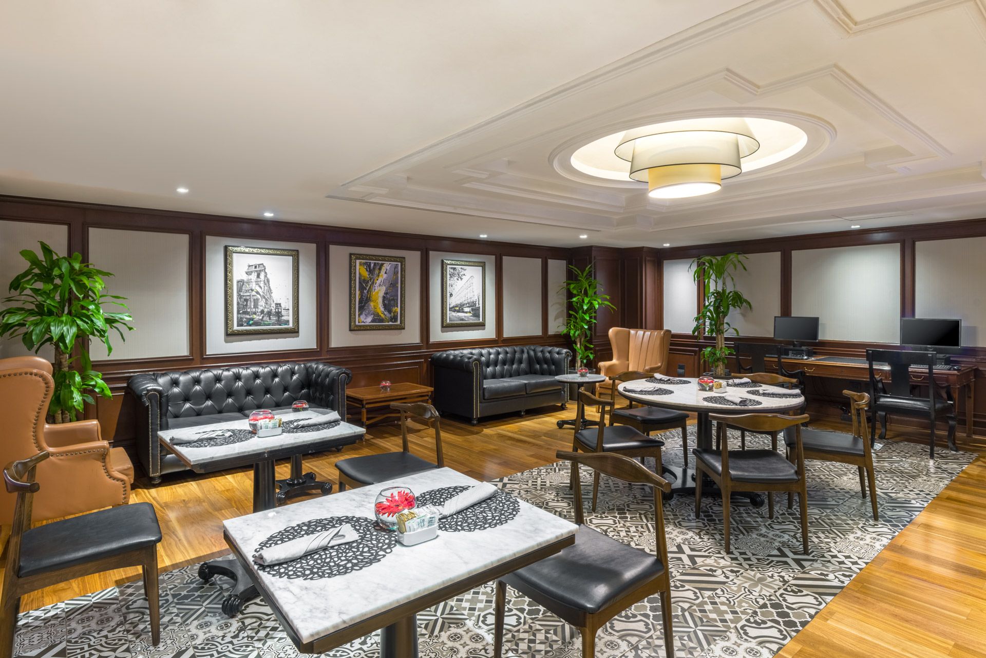 Sophisticated dining room with leather couches and patterned floor tiles. Barcelo Mexico City Reforma.