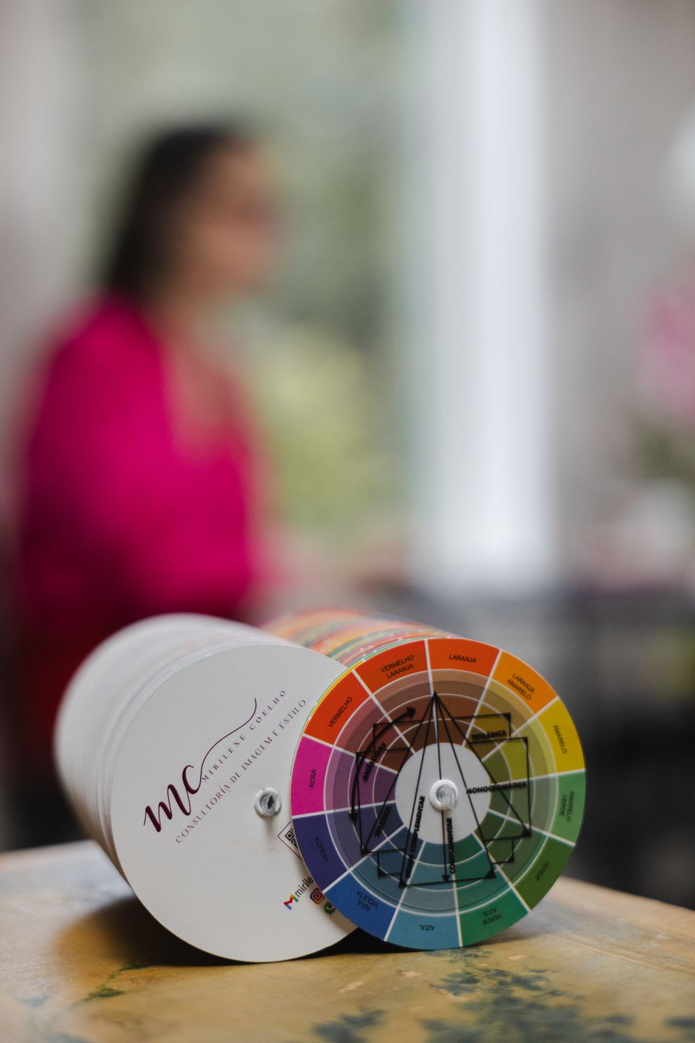 Color wheel charts showing paint or design swatches arranged in a gradient pattern on a wooden surface.