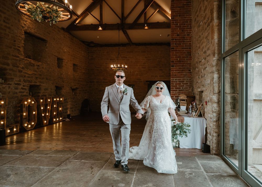 Four wedding photos showing a rustic brick venue with elegant lighting and a couple in formal wedding attire.