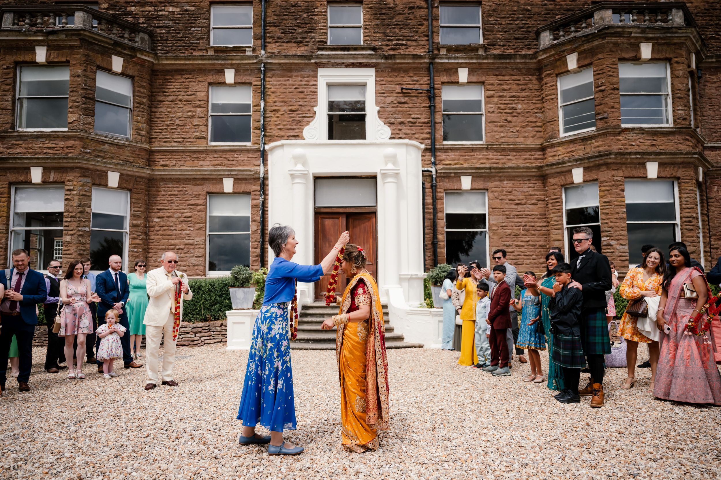 Fusion wedding reception décor at Bredenbury Court Barns with vibrant Indian colours and elegant British styling