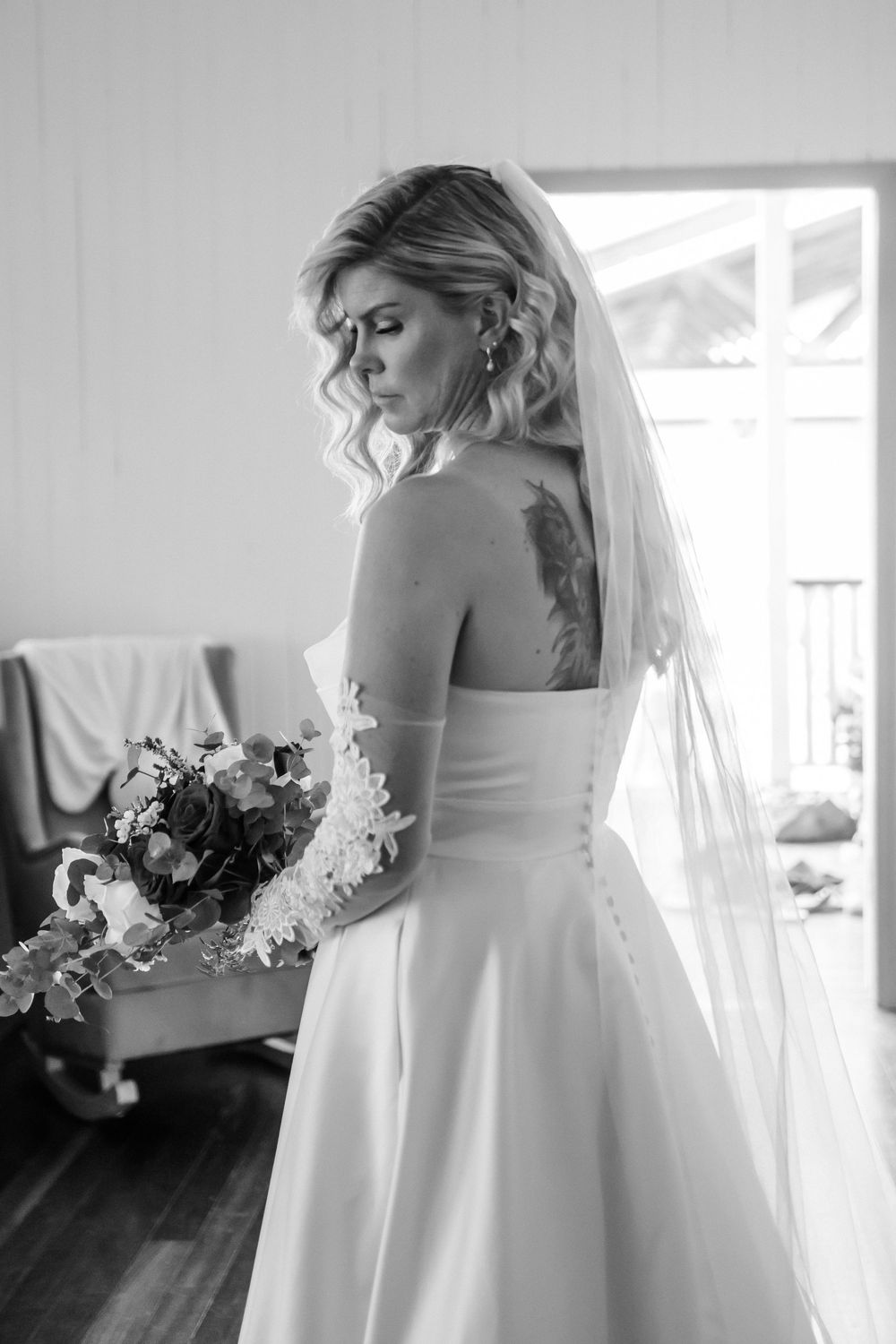 Black and white photos capturing elegant bridal moments with flowing dress and floral details.