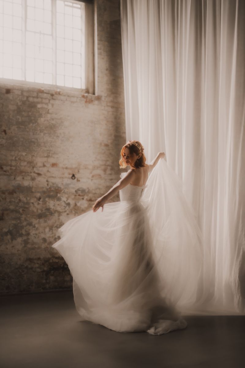 A series of artistic bridal portraits showing flowing white dress movement against sheer curtains and brick walls.