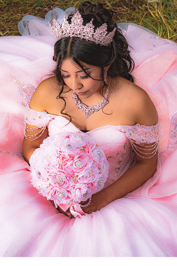 Close-up details of a pink princess gown with sparkly embellishments in an outdoor forest setting.