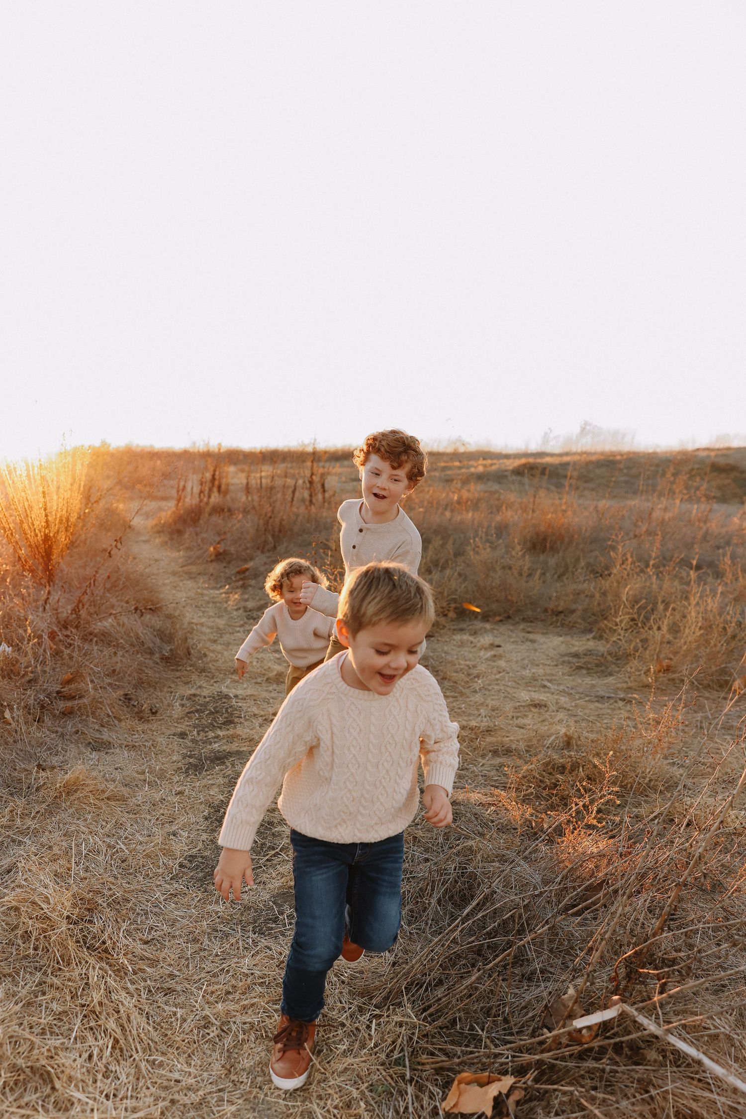 Orange County family photography moment with kids chasing each other
