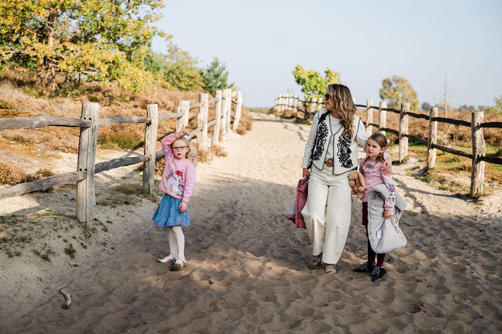 A series of candid outdoor family photos taken at sunset with wooden fencing and natural scenery in the background.