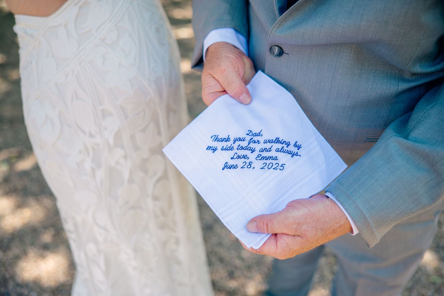 A handwritten note is being held up against a light colored background.