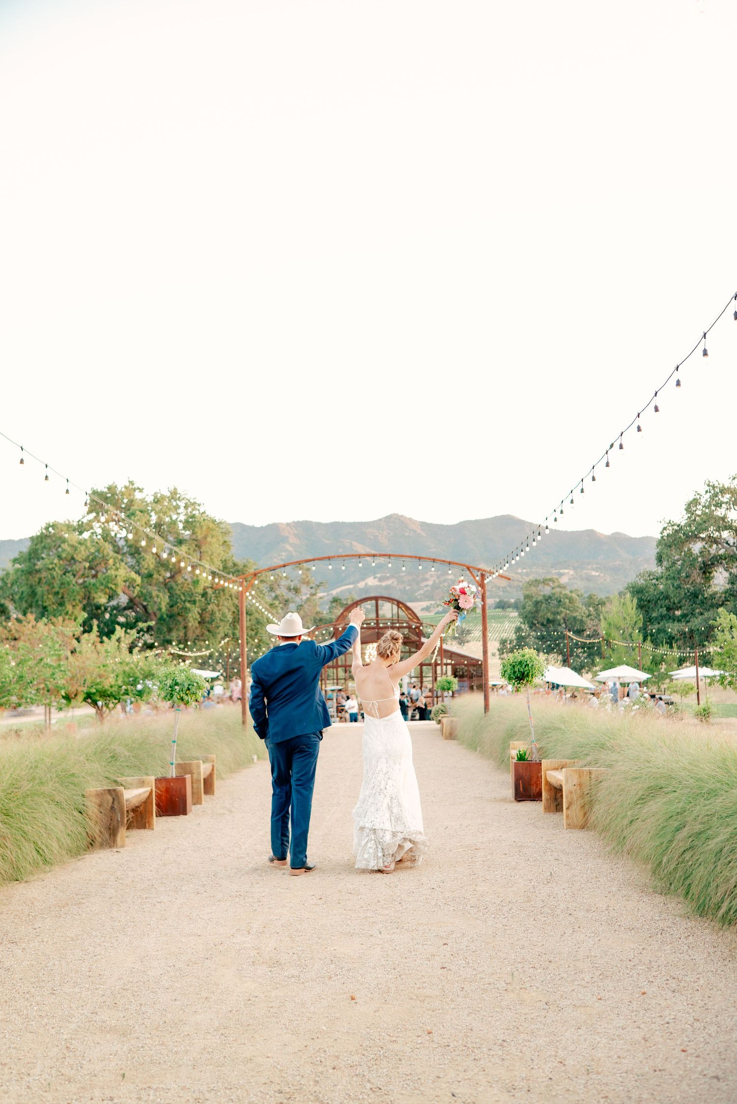 A wedding ceremony setup with rustic decor and mountain views in the background.