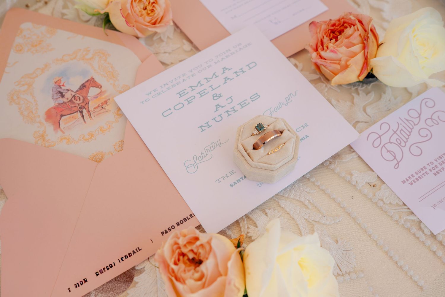 Elegant peach and white wedding invitations with floral accents.