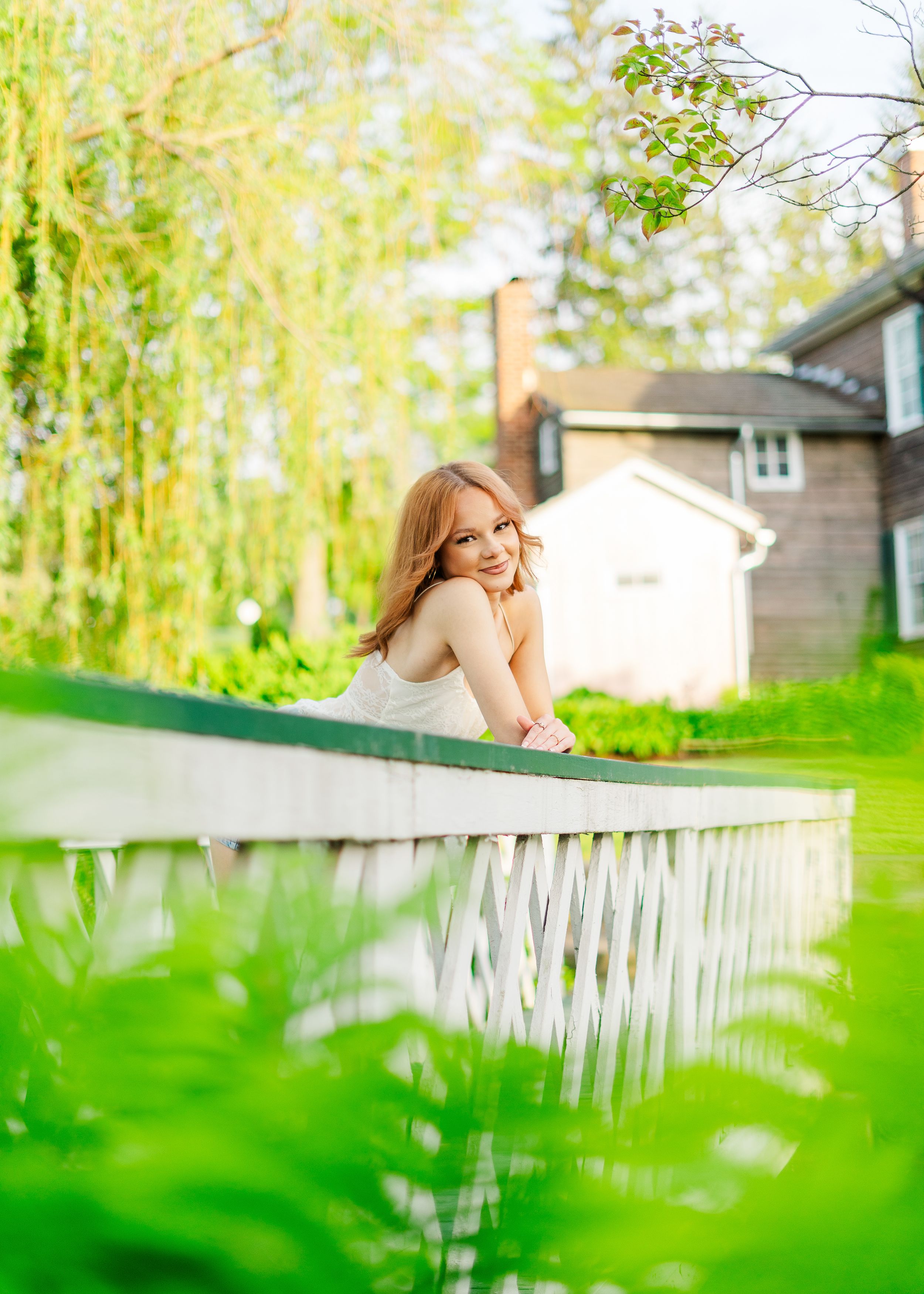 senior portrait leaning on a bridge