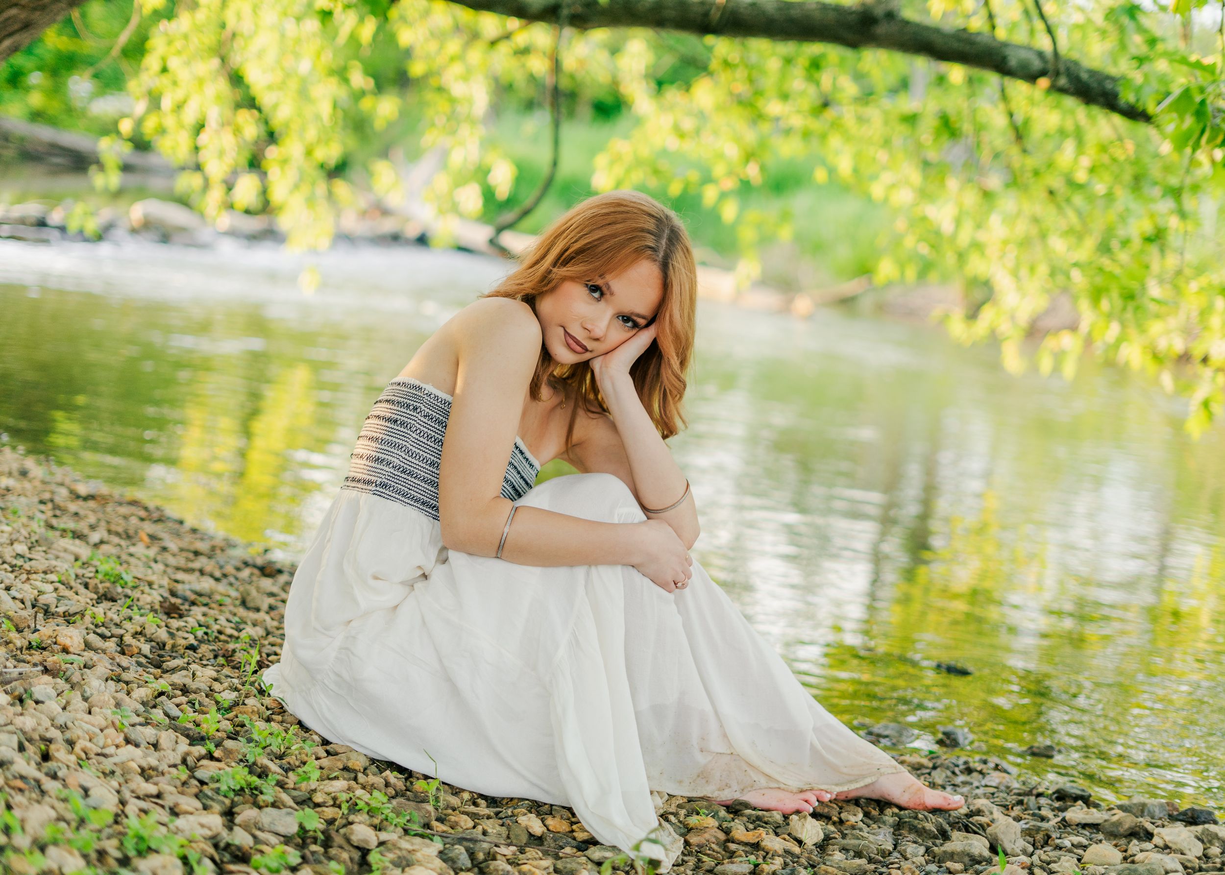 senior session next to a creek with white dress