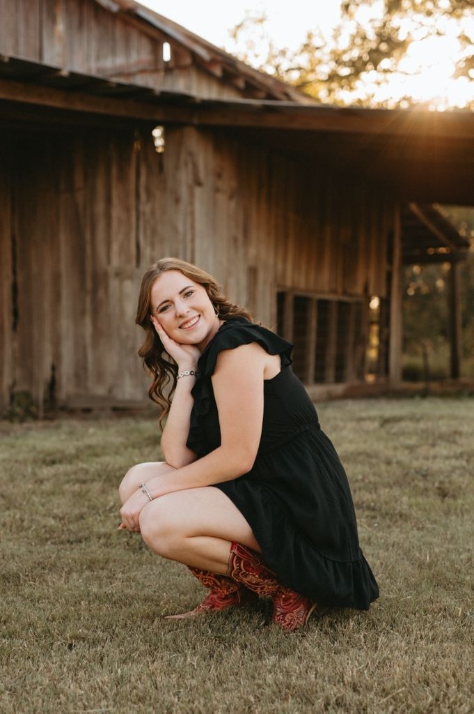 A series of sunset portraits showing someone in a black dress sitting on grass near a rustic barn.