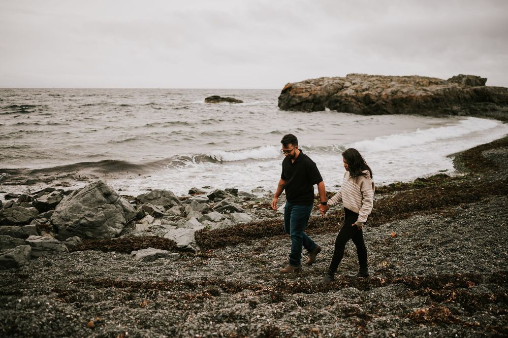 Neck Point Park, Nanaimo, Vancouver Island Engagement Photographer Photoshoot of couple walking along beach holding hands in the rain