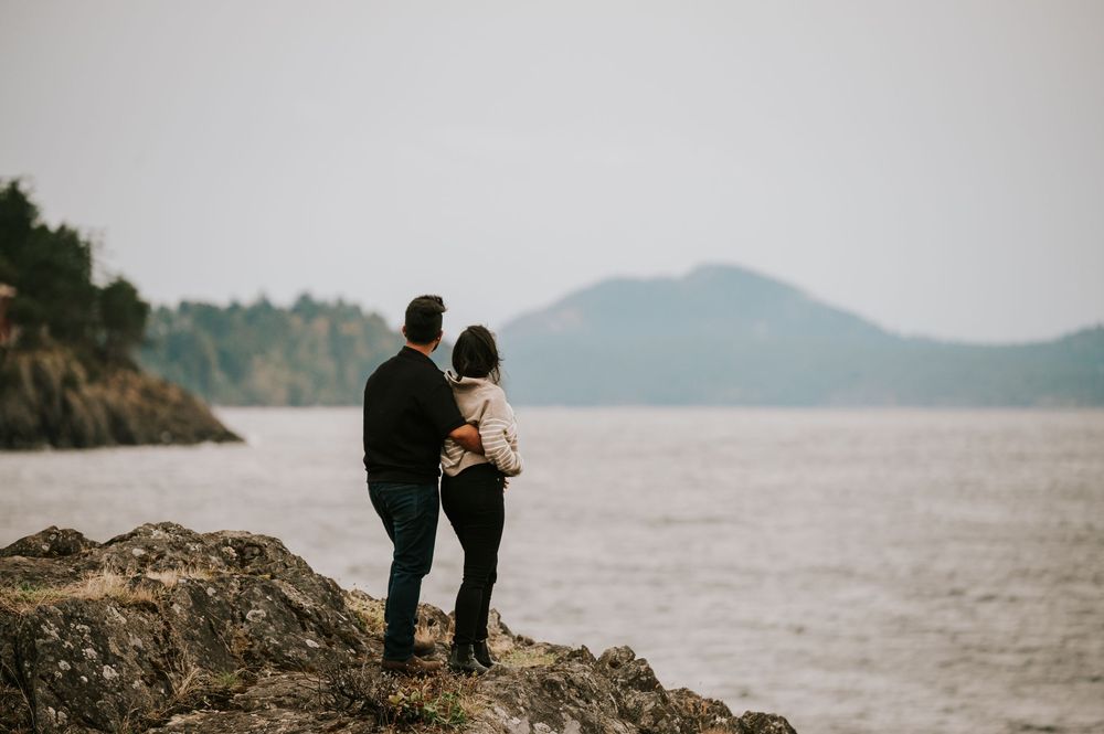 Neck Point Park, Nanaimo, Vancouver Island Engagement Photographer Photoshoot of couple looking at mountains in distance