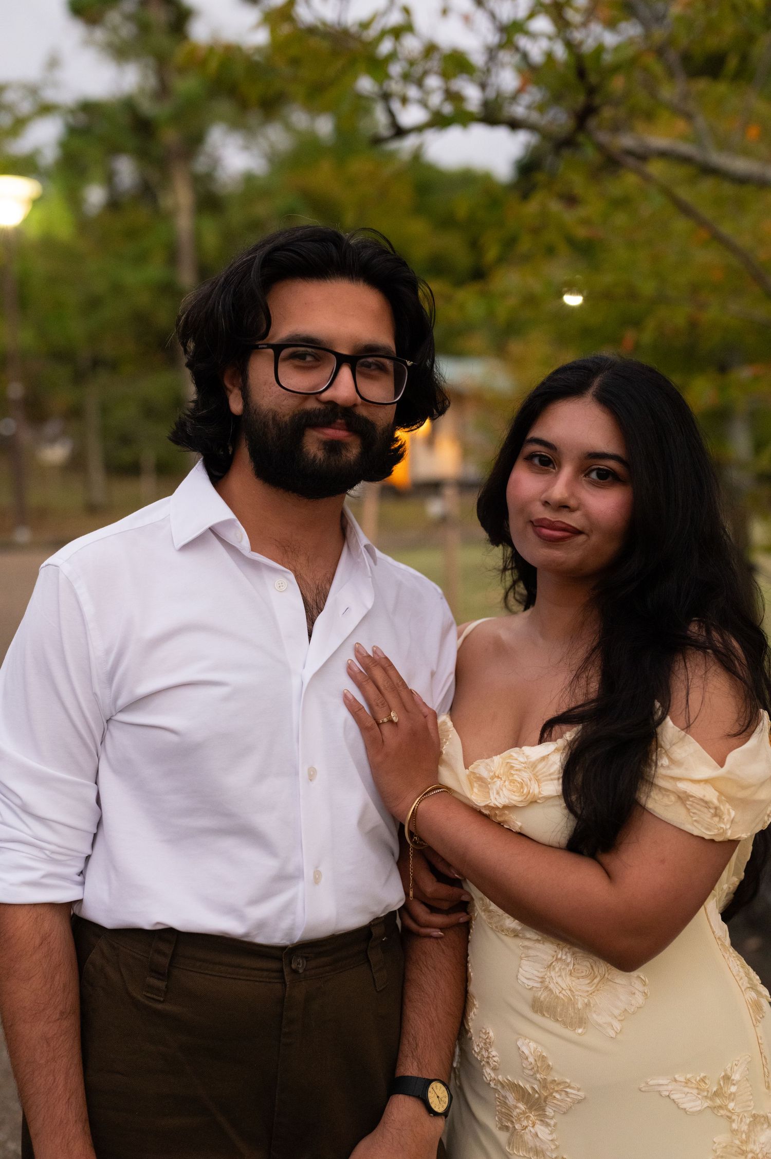Smiling couple poses together in a Japanese garden at dusk.