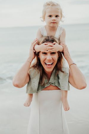 Candid beach portraits showing playful interactions and laughter.