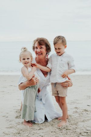 Joyful moment on beach with small children playing in the sand.