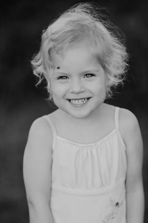 Black and white portrait series showing joyful expressions.