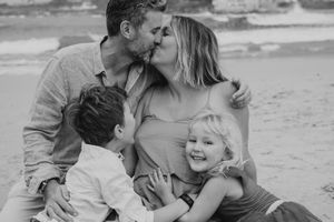 Black and white series of candid family moments captured at the beach.