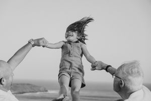 Black and white image of a child playing and jumping outdoors.