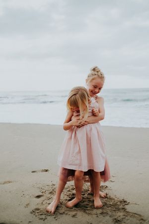 Sweet interaction between family members playing in the sand at the beach.