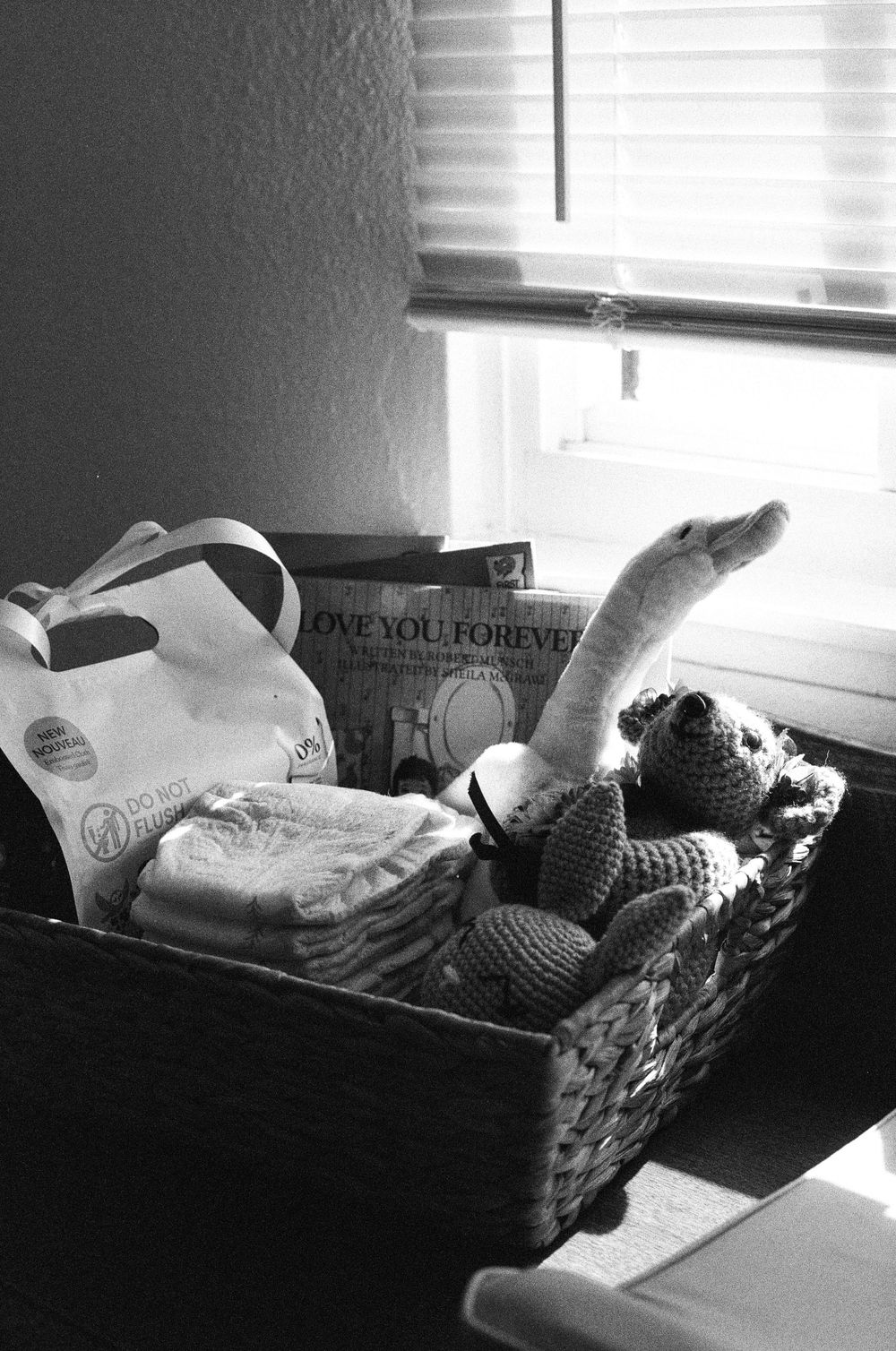 A black and white photo sequence shows a cat stretching and rolling around on a couch near a window.
