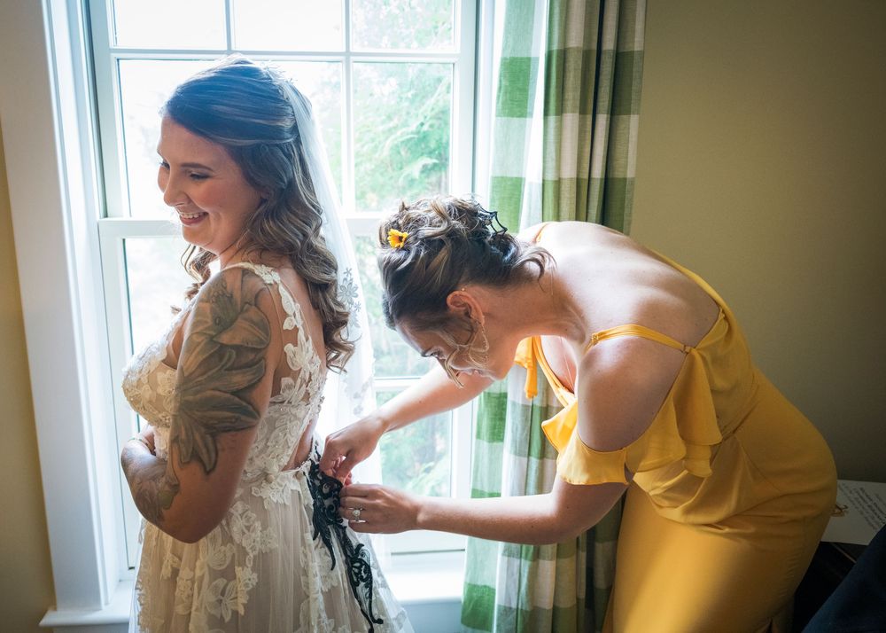 A sequence of people helping with dress preparations in a sunlit room with green curtains.