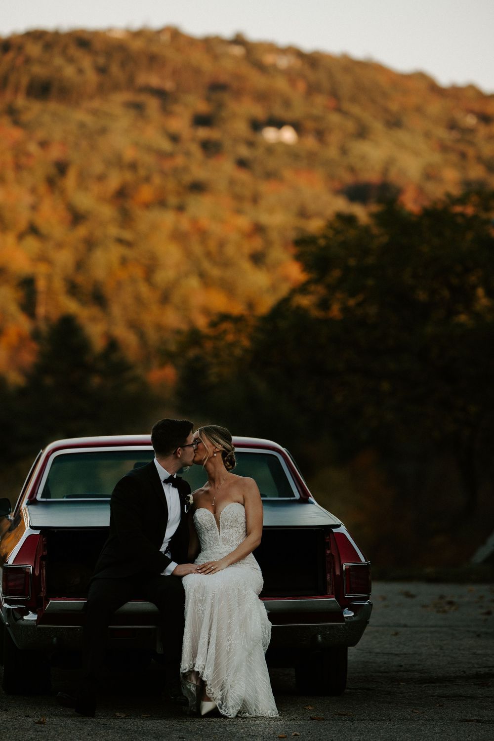 Old vintage car photography with bride and groom at their wedding.