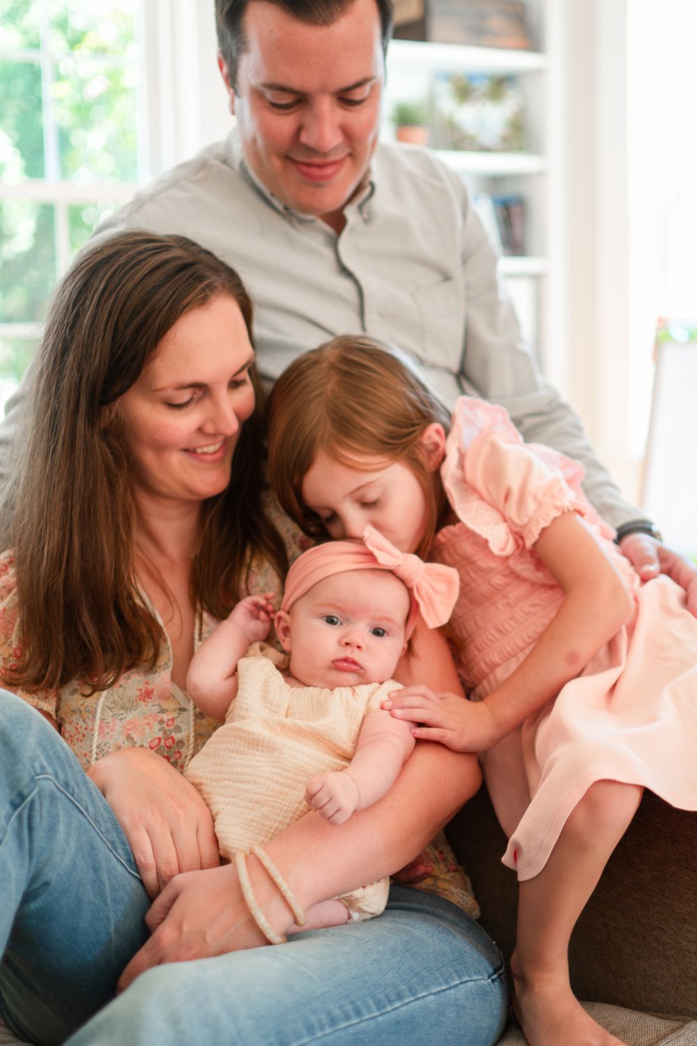 A sweet family moment captured in three connected photos showing tender interactions with a baby in peach-colored clothing.