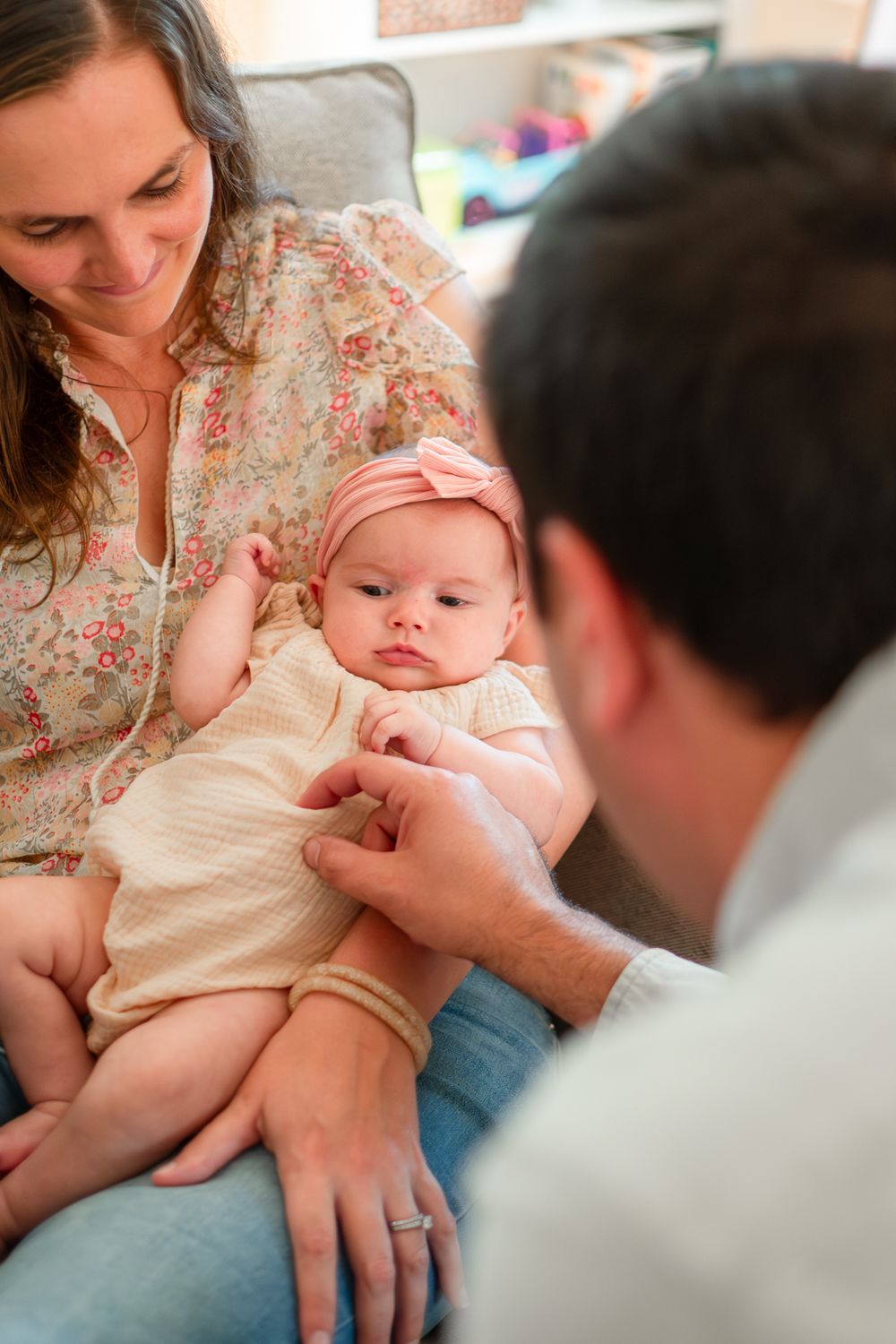 A sequence of photos showing a baby getting vaccinated while being comforted by adults.