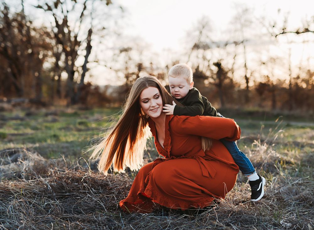 A series of outdoor portrait photos at sunset showing someone in a burnt orange sweater laying in autumn grass.