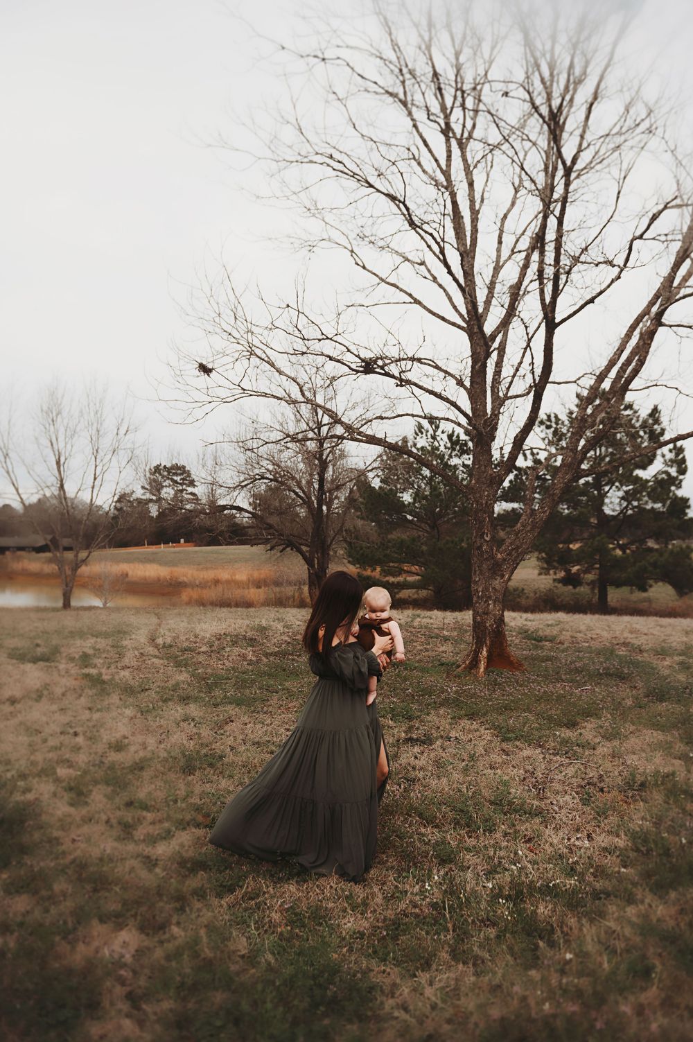 Mother holding her child in their front yard somewhere in Texas.