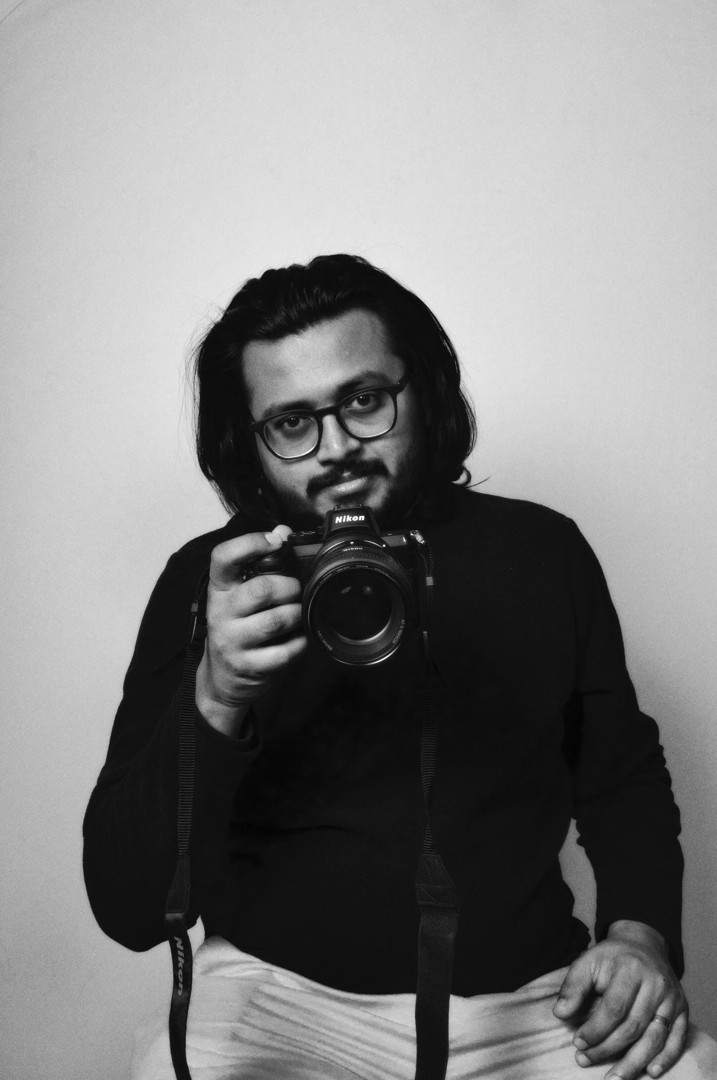 a picture of arun anand holding a camera