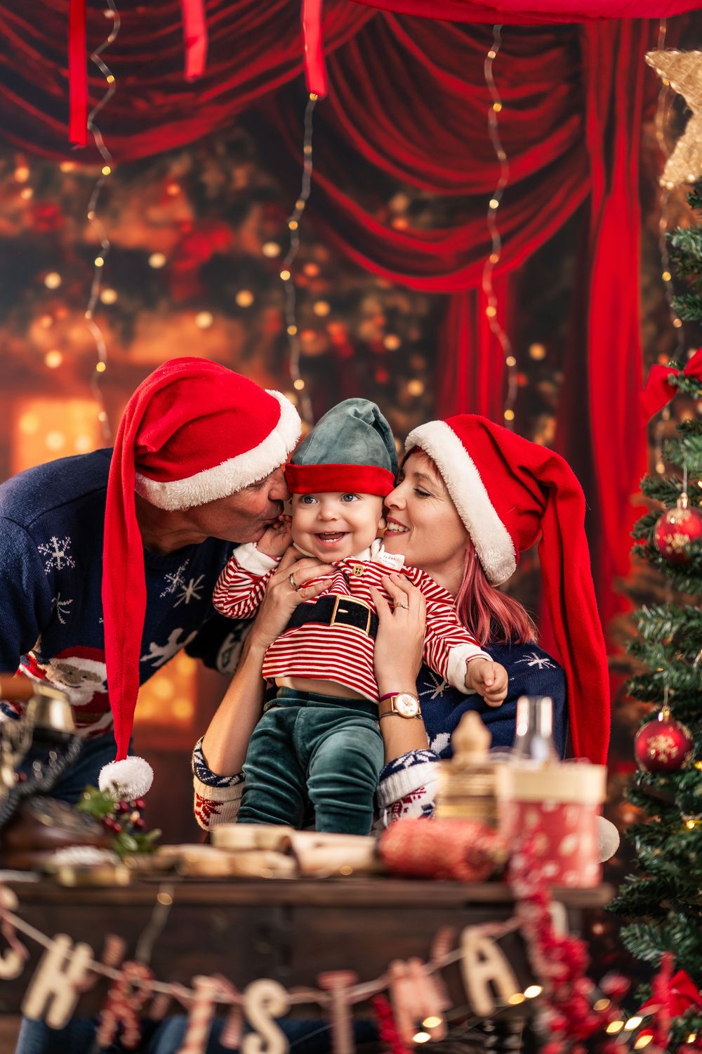 A festive Christmas scene with red curtains, decorations, and holiday lights creating a warm and magical atmosphere.