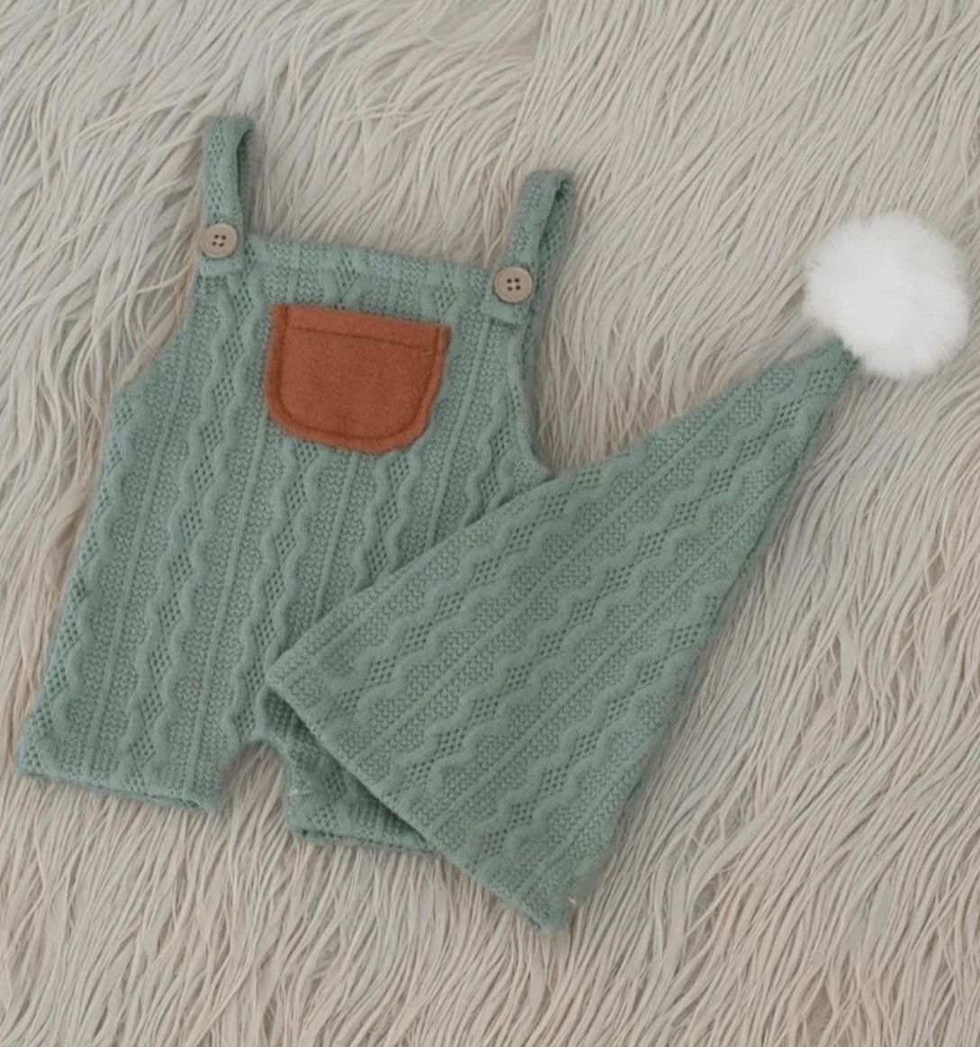 Sage green quilted baby romper with brown pocket detail and matching hat.