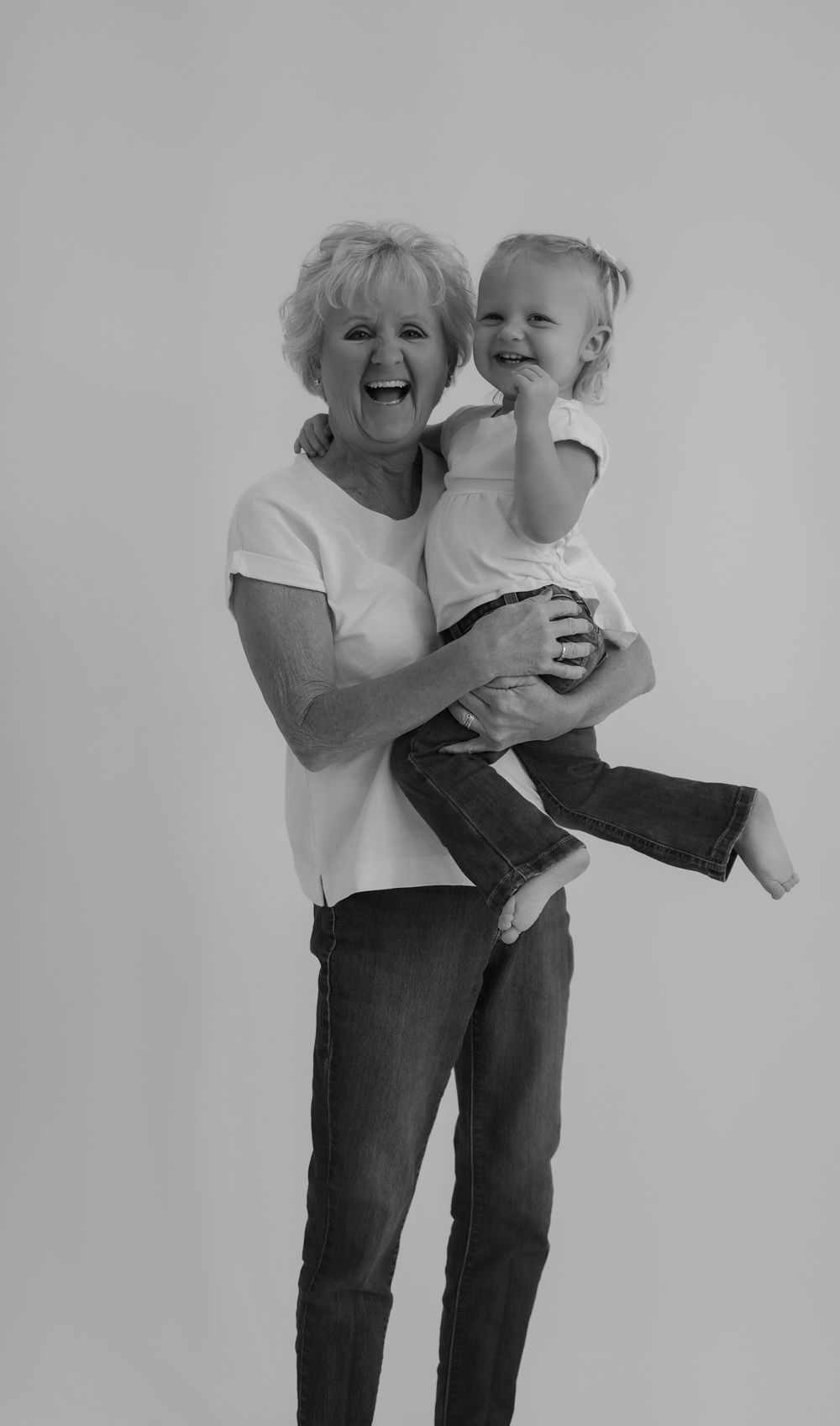 Black and white candid photography session showing joyful interactions.