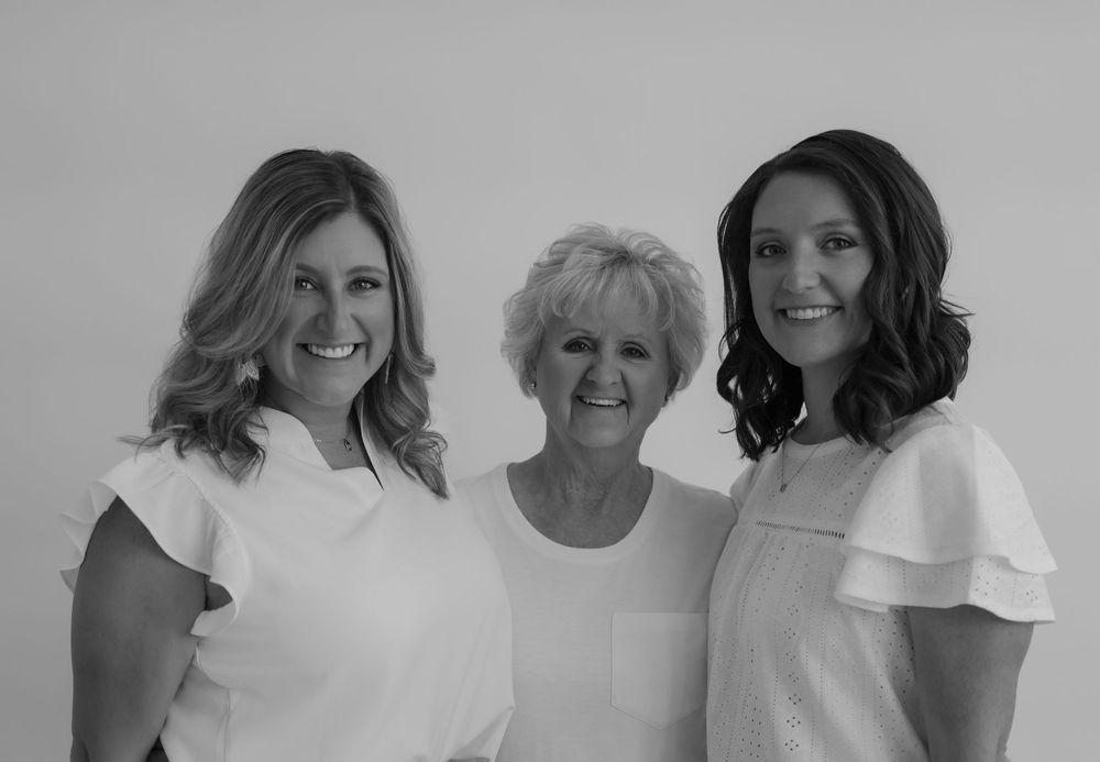 Minimalist group portrait in monochrome showing natural expressions.