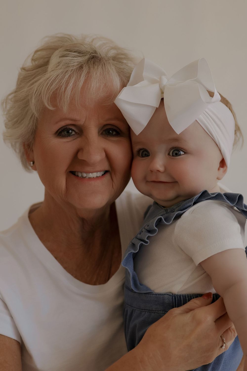 Heartwarming close-up shots showing affectionate moments against a neutral backdrop.
